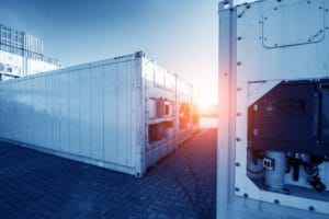 Mehrere Kuehlcontainer und Tiefkuehlcontainer stehen im Verladebereich eines Hafen