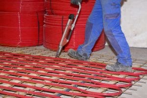 Verlegung von roten Rohren zwecks Betonkernaktivierung im Rohbau